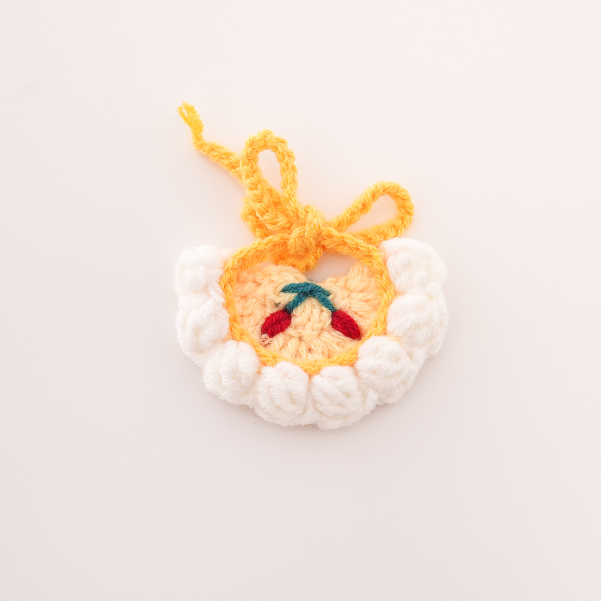 Yellow bib with white trim and cherry