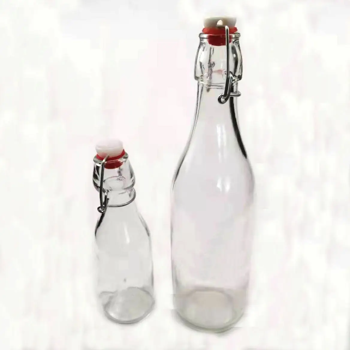 Precio bajo Clear Flip Top Bottle 250 ml 500ml 750ml 10000ml Swing Top Beer Bebida Botella de vidrio con tapón hermético