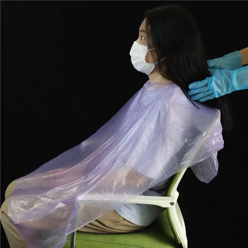 Cape en plastique de salon de beauté Tablier PE jetable imperméable pour la coloration des cheveux dans les salons de coiffure