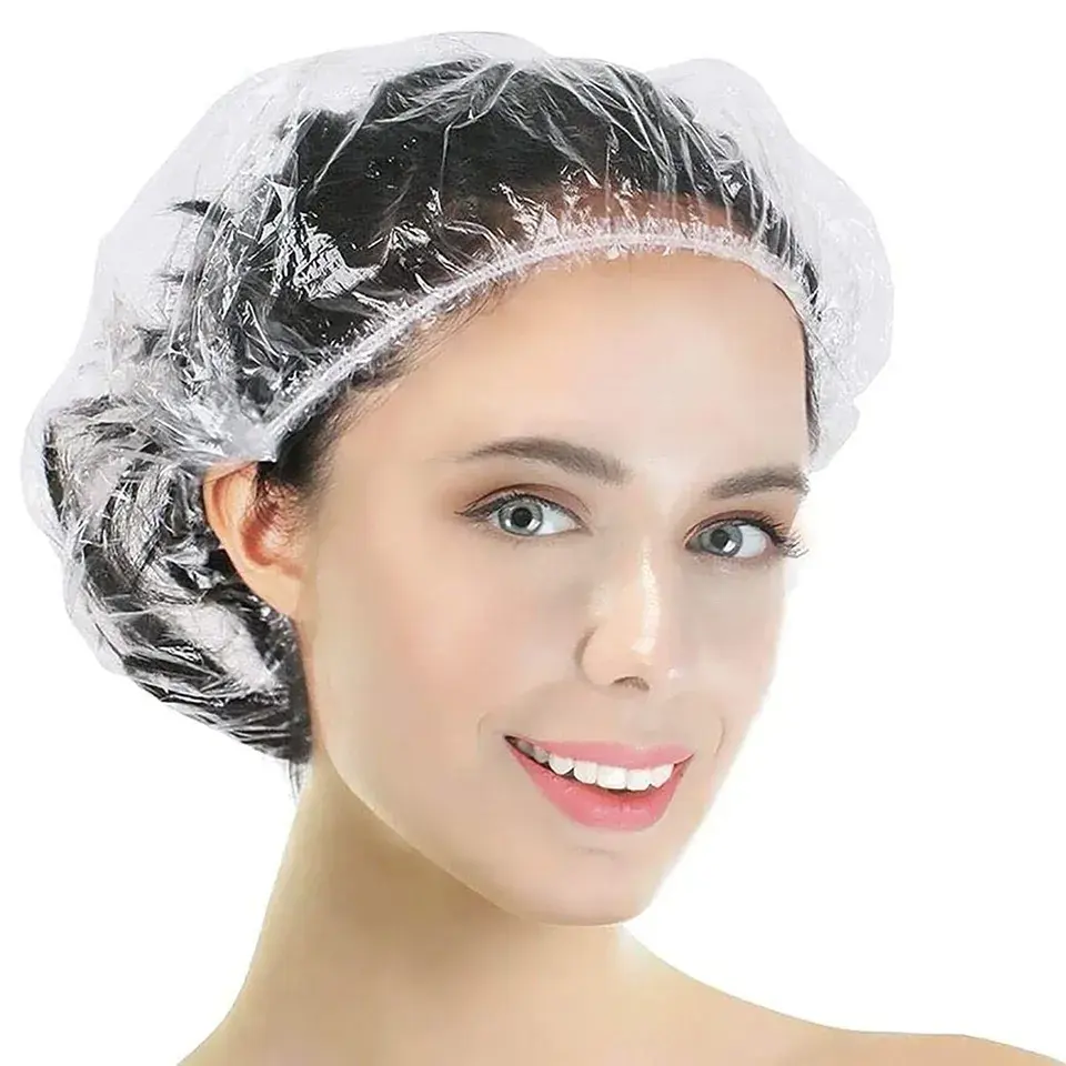 Gorro de ducha de pelo transparente desechable de plástico resistente al agua para procesamiento de cabello para mujer peluquería SPA Hotel viaje con alta calidad