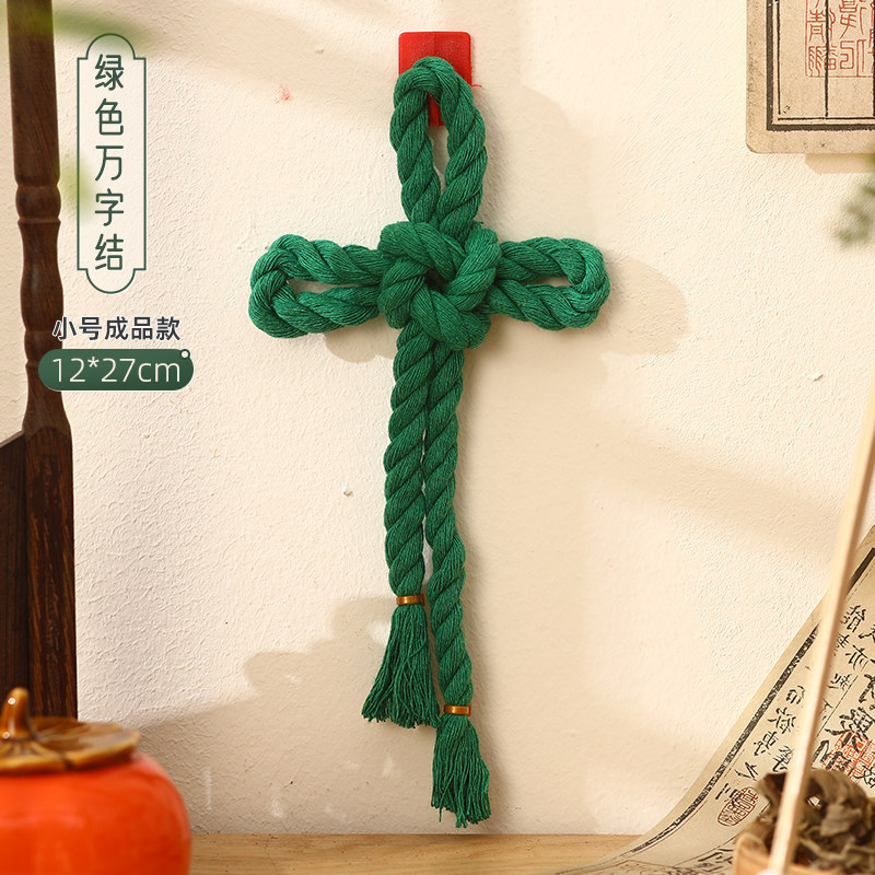 Petit nœud en forme de croix gammée verte.