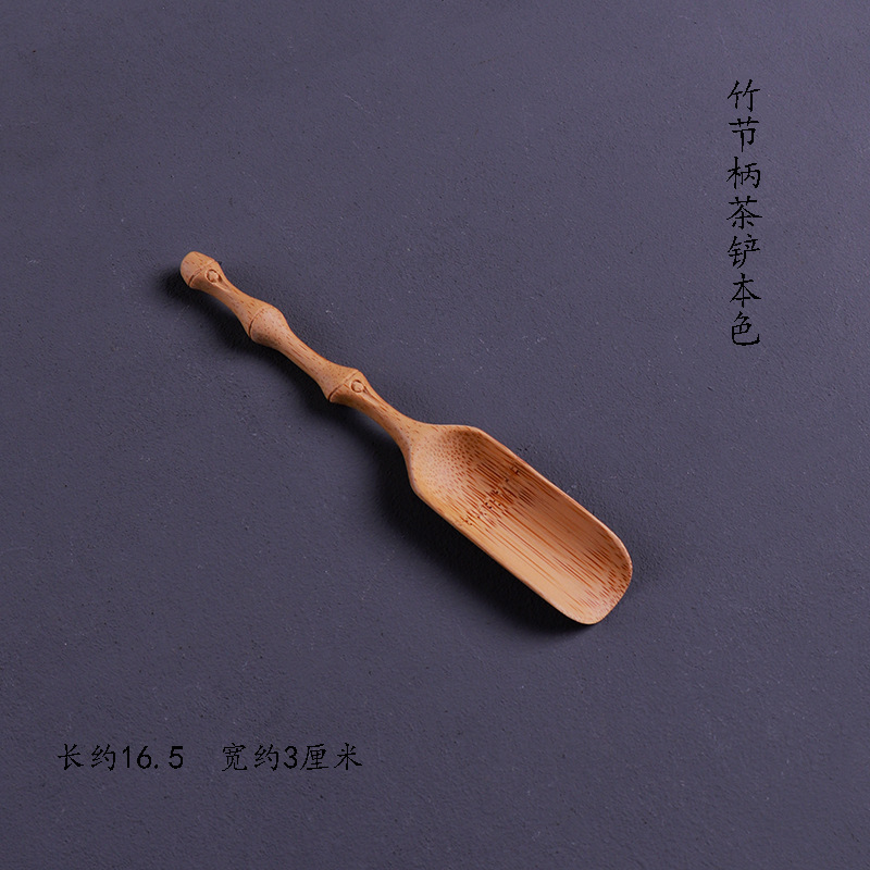 Light-colored bamboo-handled tea spatula