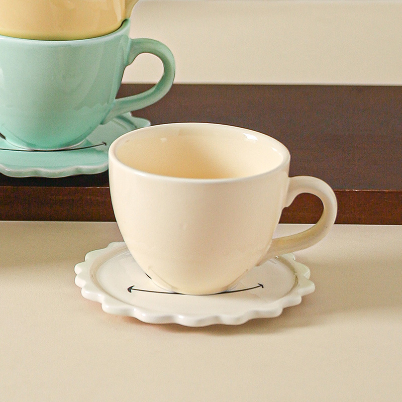 Cream-colored coffee cup and white saucer set