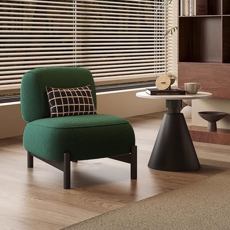 Fauteuil individuel en laine d'agneau vert foncé avec coussin.