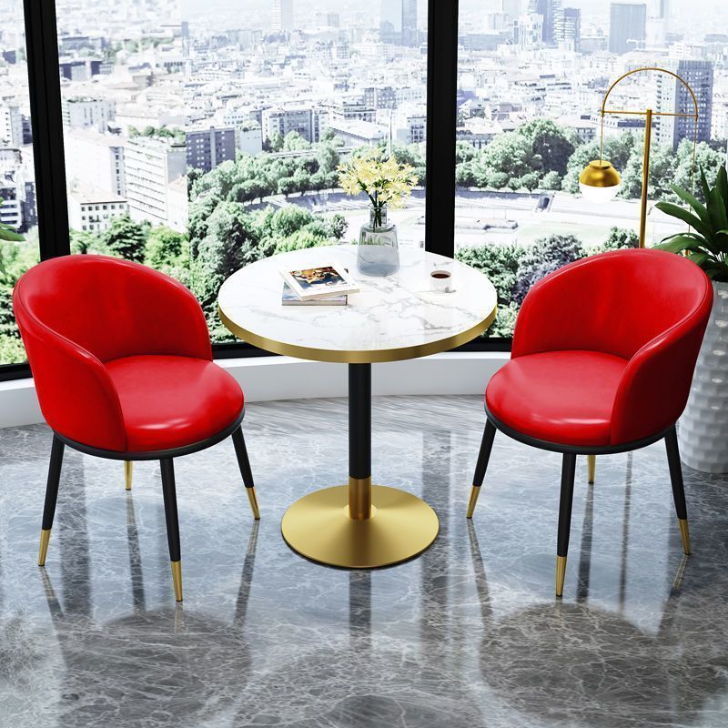 Red leather chair imitation stone round table