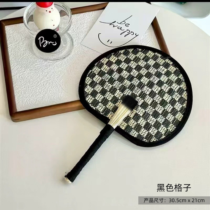 Black woven palm leaf fan