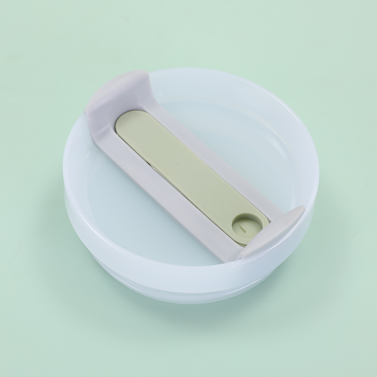 Blanco lechoso, cuerpo gris, lámina verde matcha de 9 cm.
