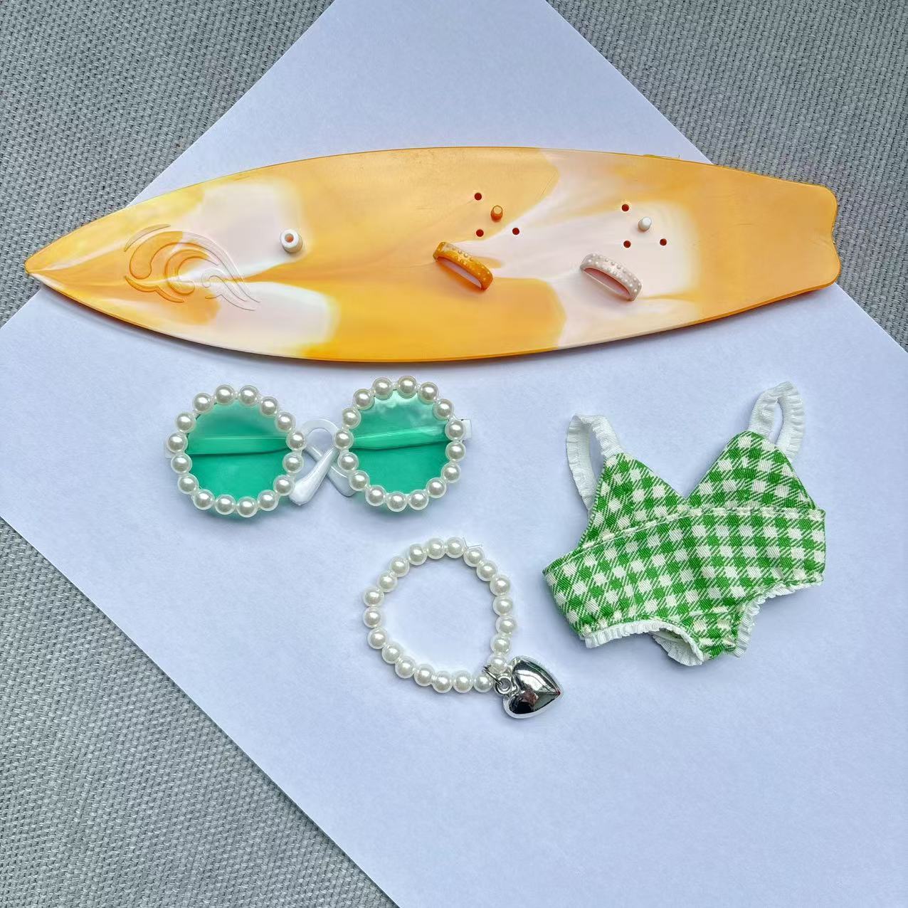 Green swimsuit yellow surfboard necklace green glasses