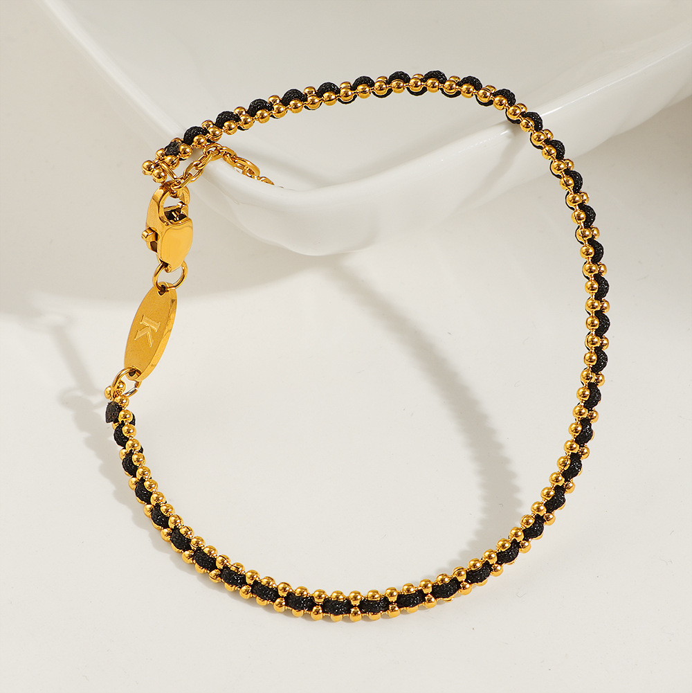 petit bracelet en corde noire tressée dorée