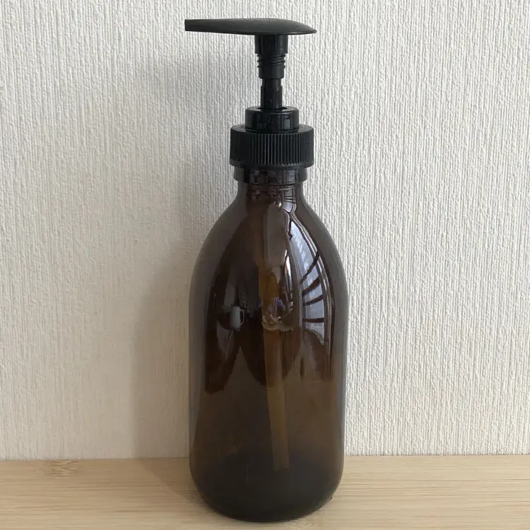 Bouteille en verre d'huile corporelle de lotion de savon ambré épais de 300ml 10oz avec la pompe pour l'huile cosmétique de cheveux