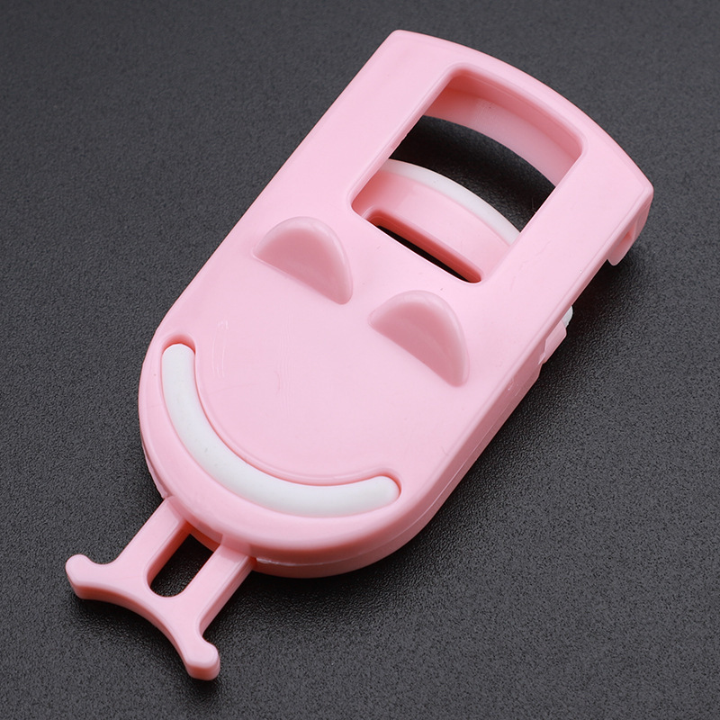 Pink smiley eyelash curler