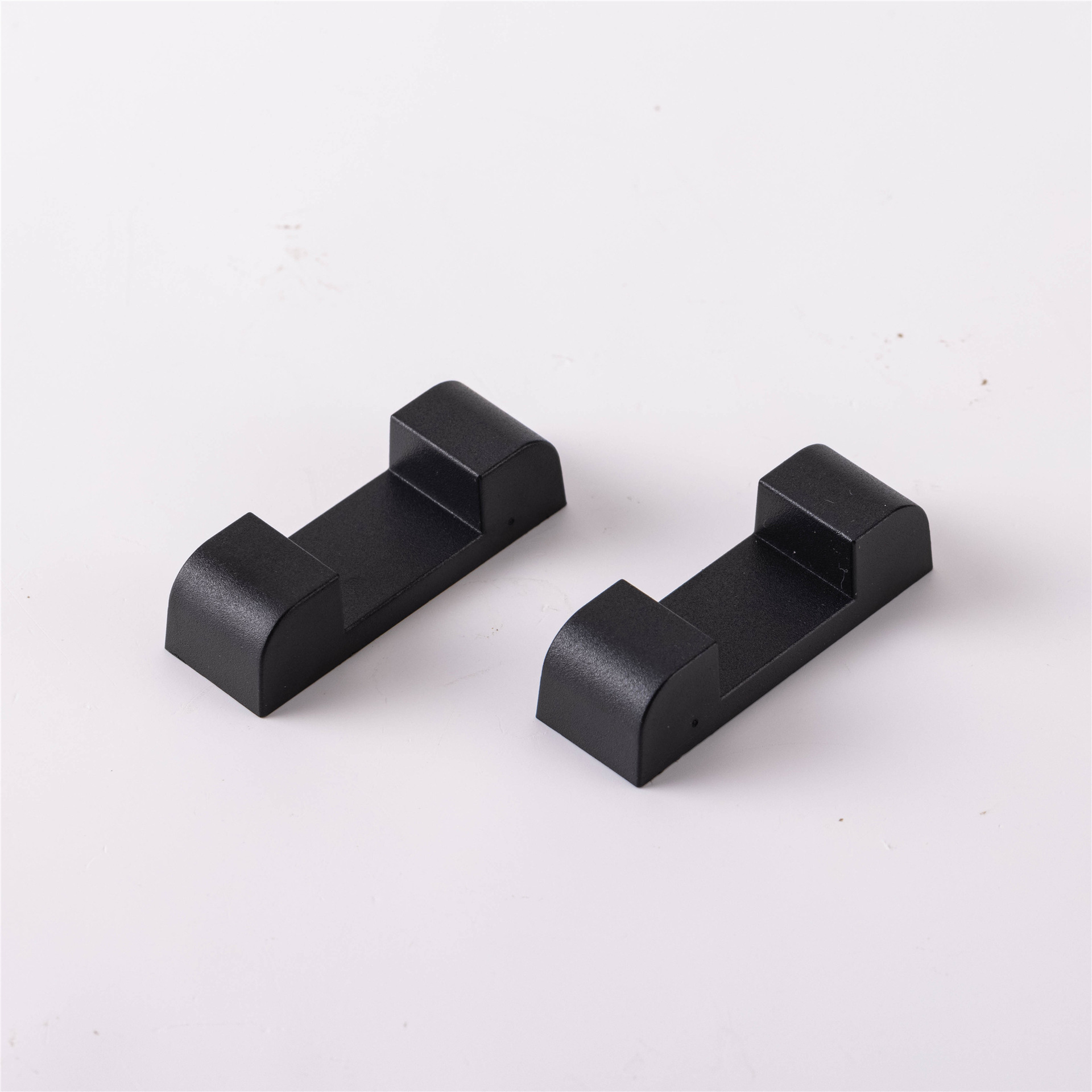 A pair of black square bases