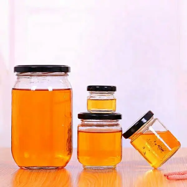 Jarra de miel de vidrio transparente, redonda, de grado alimenticio, fabricada en fábrica