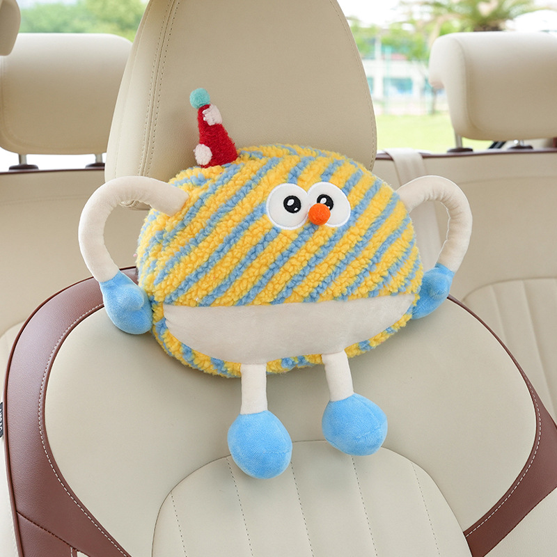 Appui-tête monstre en peluche à rayures jaunes
