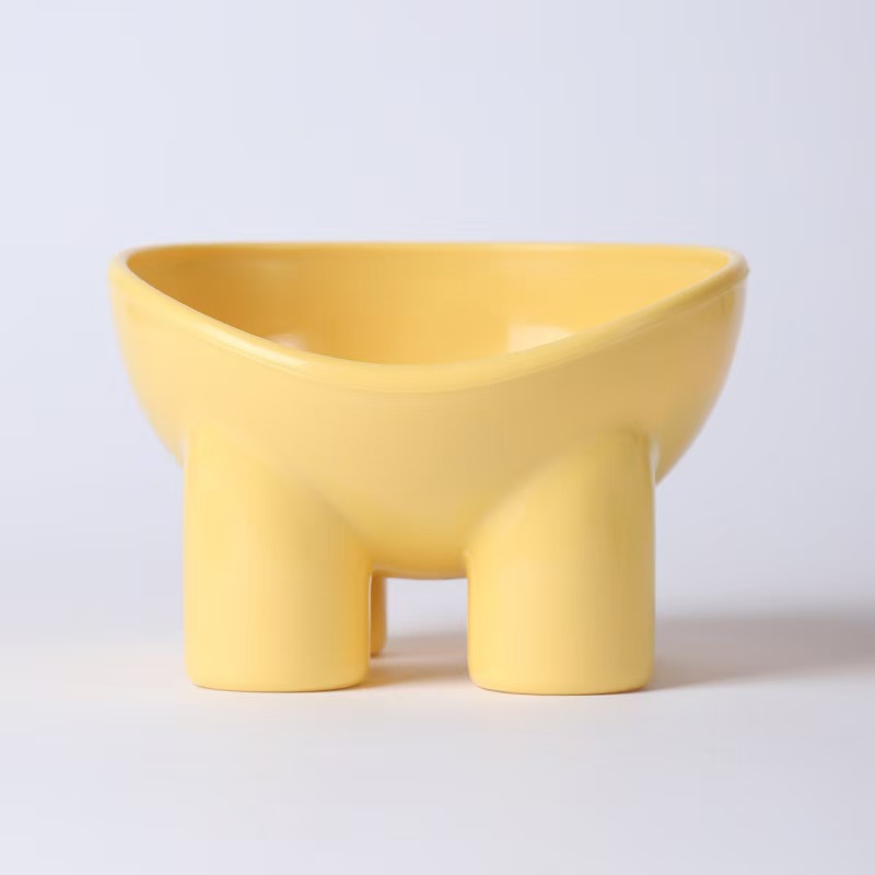 Tazón para mascotas con forma de pata de elefante, color amarillo.
