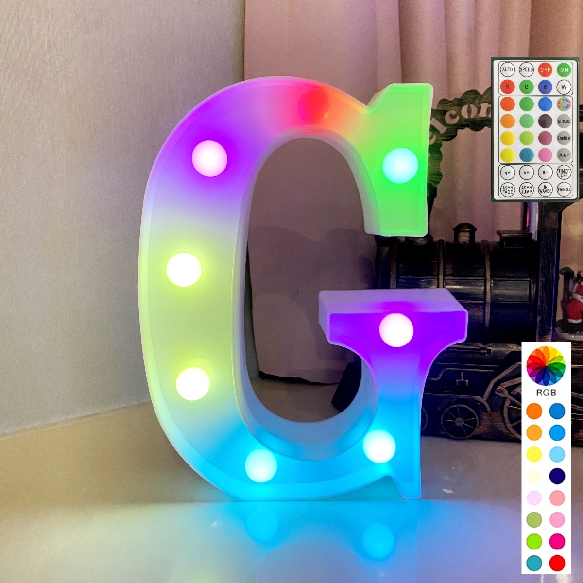 Lettre colorée synchronisée avec télécommande sur fond blanc : g