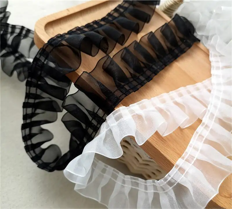 Precio al por mayor tejido de encaje popüler sınır dantel kumaş renkli pileli örgü dantel elbise için kırpma