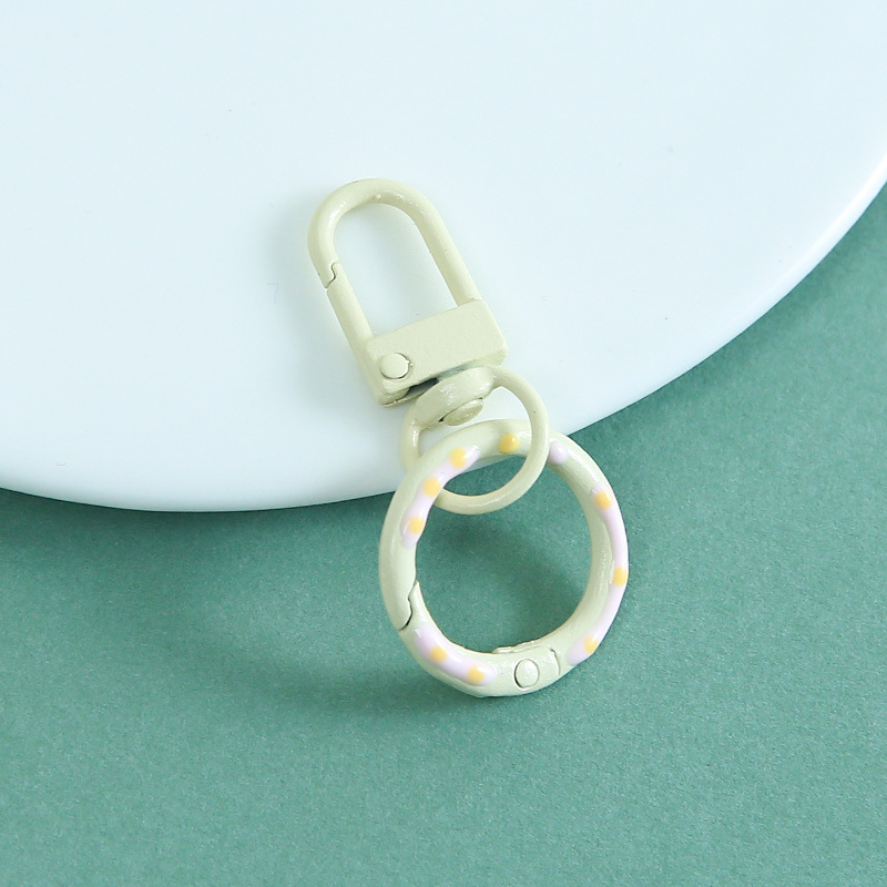 Off-white donut-shaped spring door latch