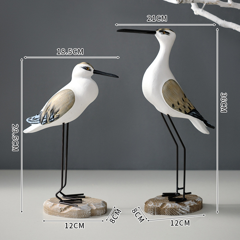 A set of round-carved yellow and white bird ornaments