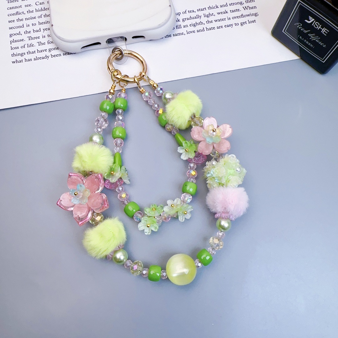 Chaîne courte pour téléphone avec boule lumineuse fleurie, rose et verte, style industriel lourd.