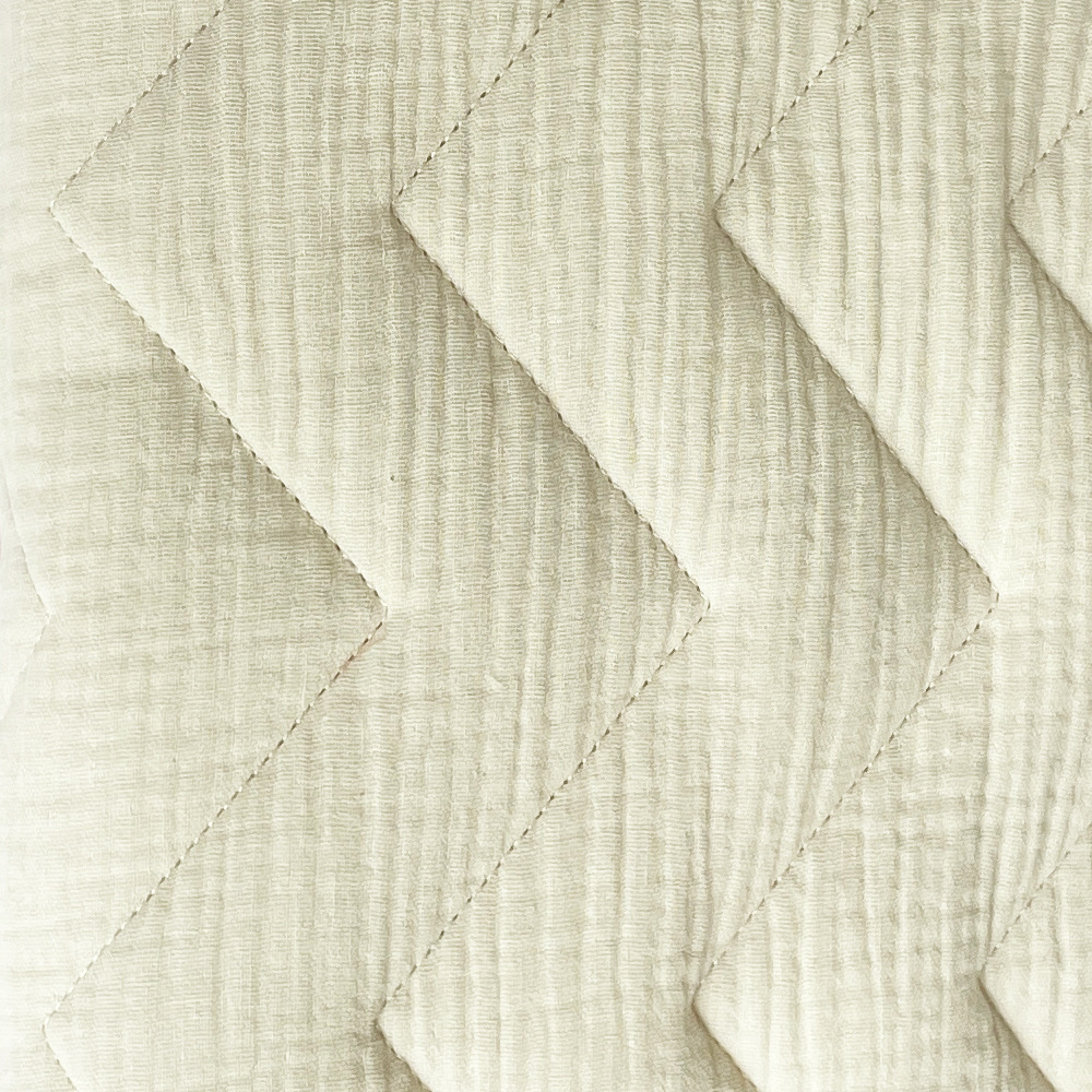 1 cream white-quilted bedspread