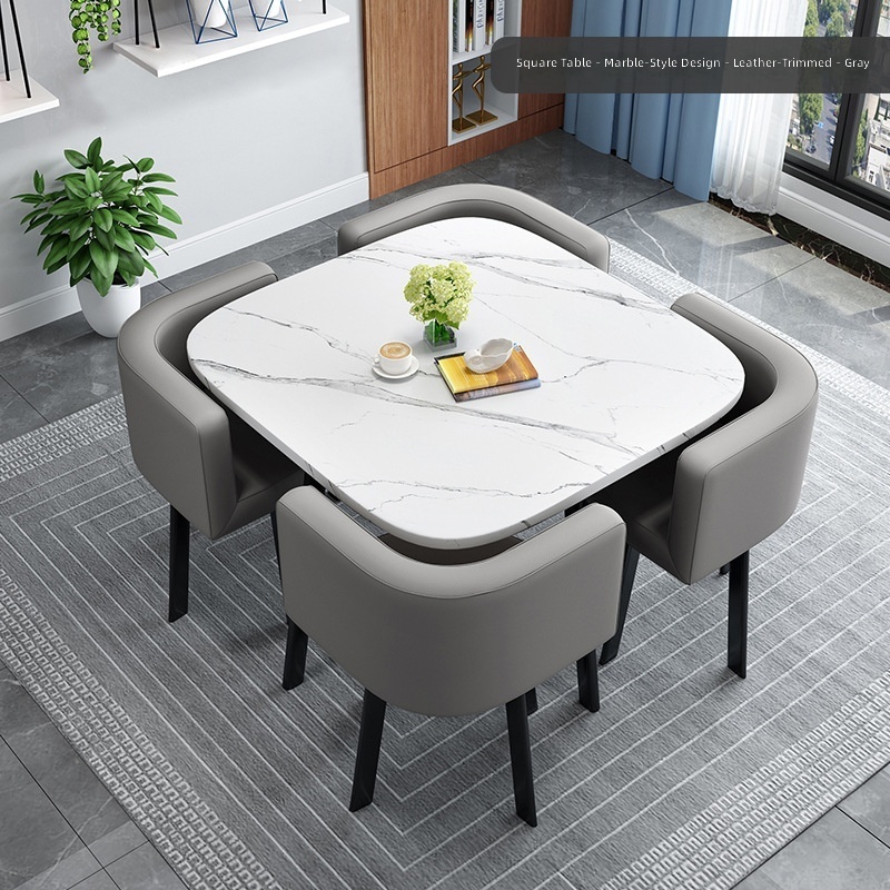 Mesa cuadrada con diseño de imitación de piedra, tapizada en cuero gris oscuro.