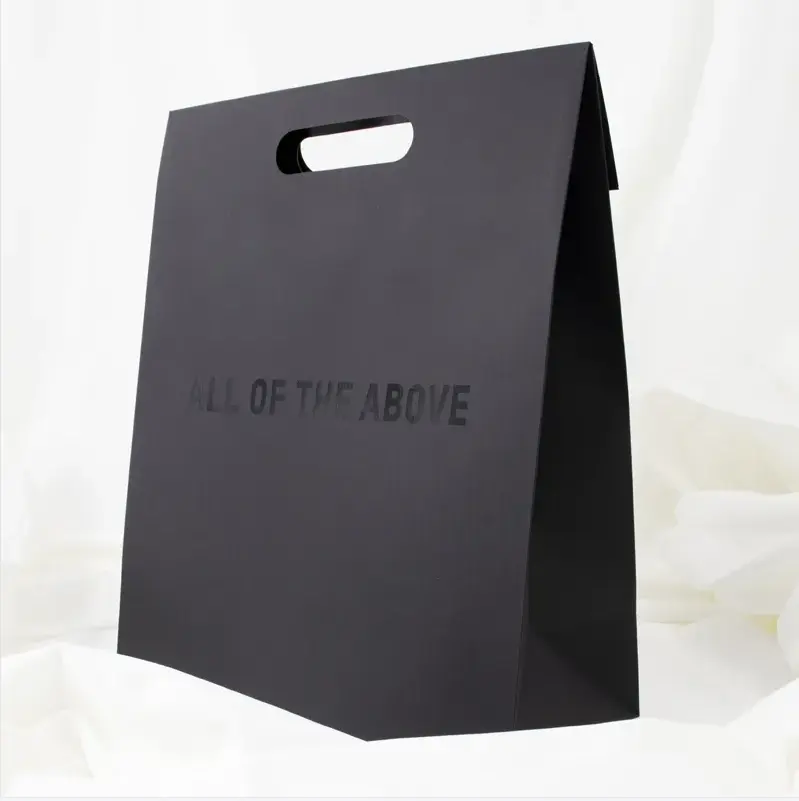 Bijoux de luxe cadeau cosmétique conception personnalisée poignée découpée noir vêtements emballage commercial sac en papier kraft blanc pour vêtements