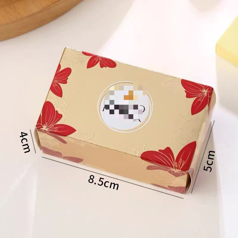 Caja de peonías con champán y chocolate.