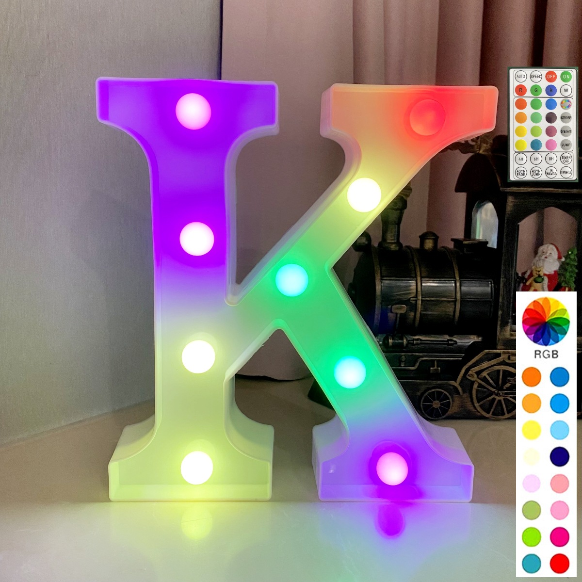 Lettre colorée synchronisée avec télécommande sur fond blanc : k
