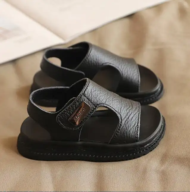 Sandalias planas huecas de cuero para niños, zapatos de playa informales para bebés, a la moda, precio de fábrica