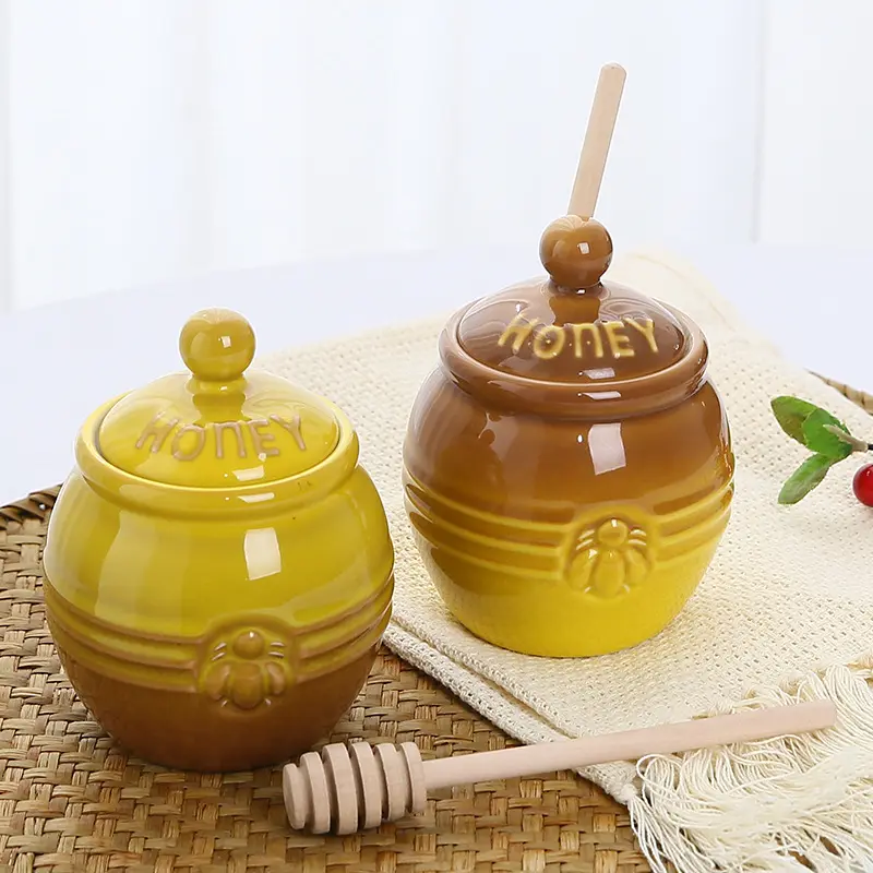 Wholesale home kitchen microwaveable yellow bee embossed ceramic honey jar with wooden dipper