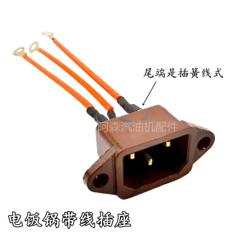 Enchufe de baquelita marrón con placa de cobre y cable instalado.