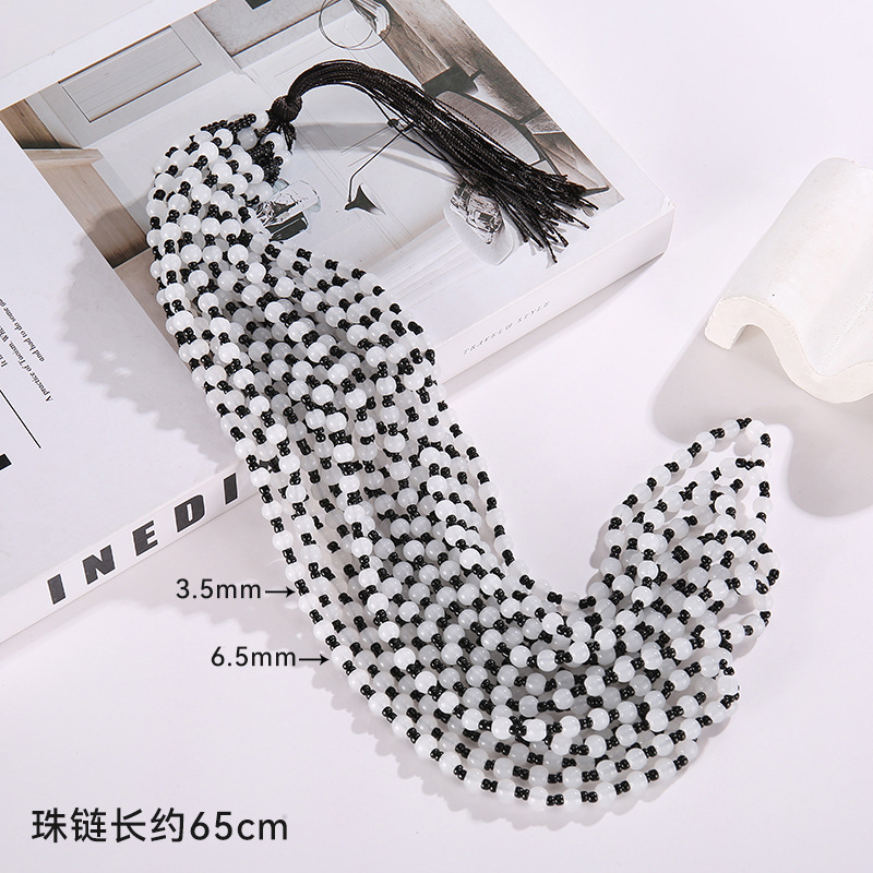 11 perles rondes imitation jade blanc avec petites perles noires