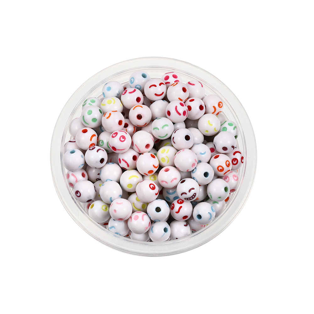 Perles sphériques blanches et colorées avec visage souriant