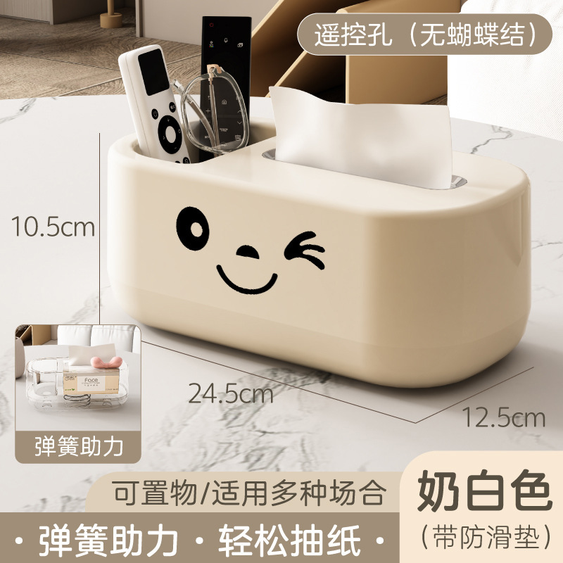 Off-white tissue box with large stickers and no bow