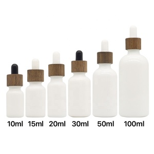 Garrafa de vidro brilhante de luxuosa, 2oz/<span class=keywords><strong>10ml</strong></span>/20ml/30ml/50ml/100ml, óleo essencial vazio, olho de porcelana branca, com parafuso de madeira