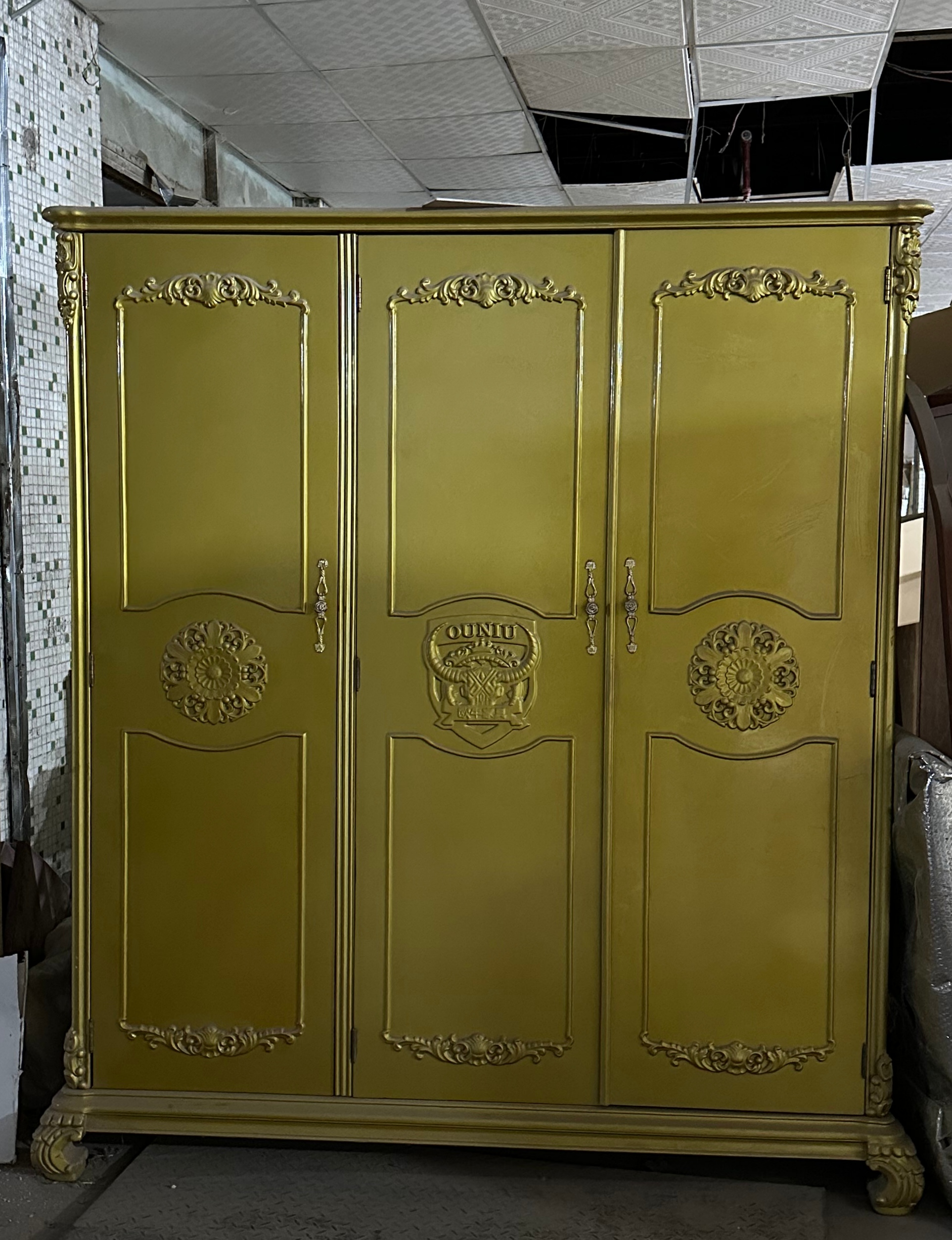 Golden three-door wardrobe.