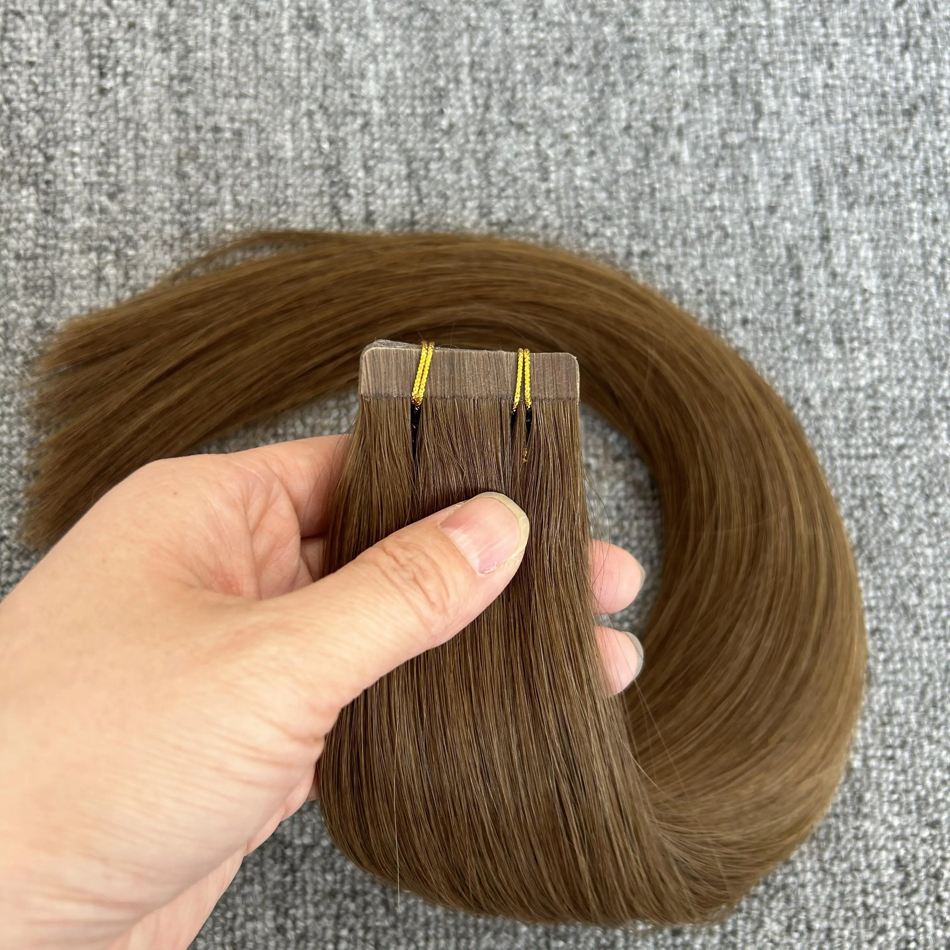 Cinta de calidad superior al por mayor en cabello crudo 100 humano ruso 12-30 pulgadas cinta de cabello humano virgen marrón en extensiones