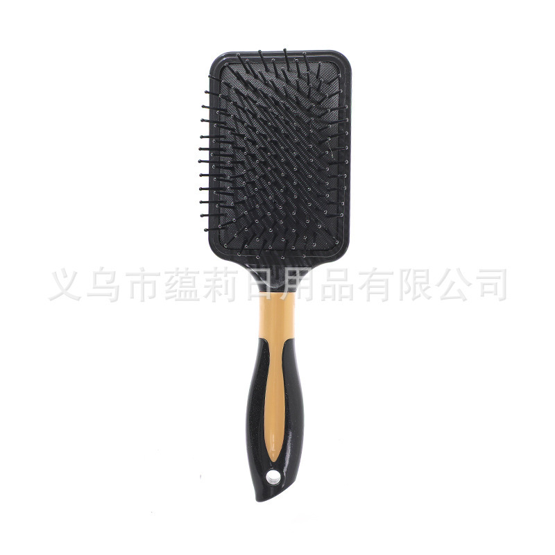 Black square brush with gold central ring cushion comb