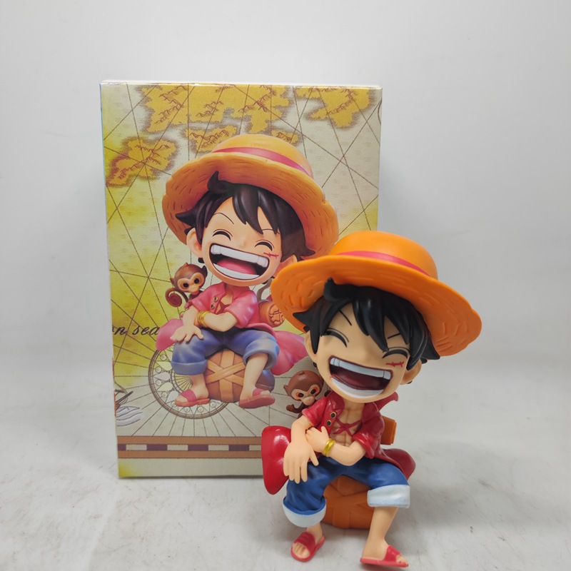 Sitting with a smiling face, Luffy in a red dress