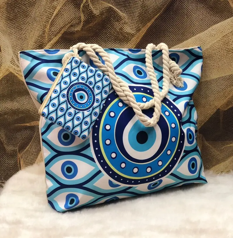 Bolso de mano con estampado retro de nicho de mal de ojo al por mayor, bolso de playa de hombro retro clásico con mini monedero colgante para mujer