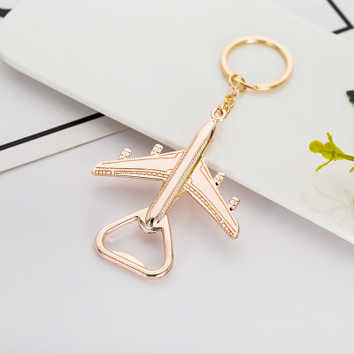 ouvre-bouteille en or rose - forme d'avion