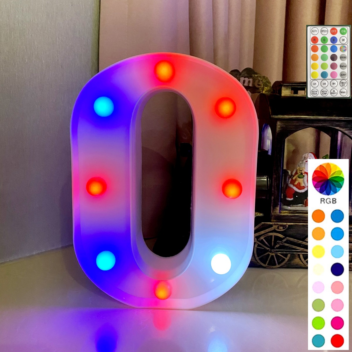 Base blanche avec lettre "o" et télécommande synchrone multicolore.
