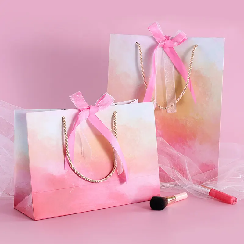 Bolsas de papel con asas para embalaje de ropa, bolsas de embalaje con estampados personalizados, color rosa, para bodas, días especiales, venta al por mayor