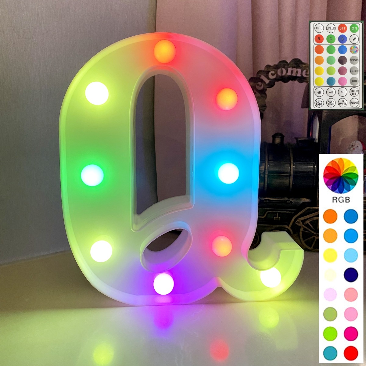 Lettre colorée de fond blanc de télécommande synchrone: q