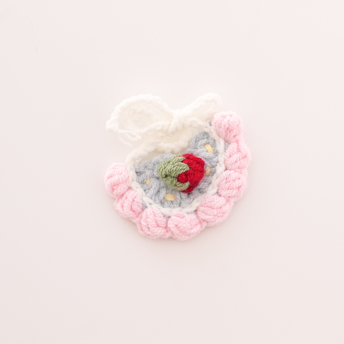Blue bib with pink trim and red strawberry