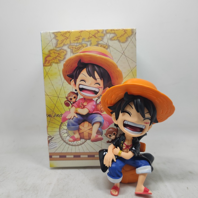 Seated smiling Luffy in black