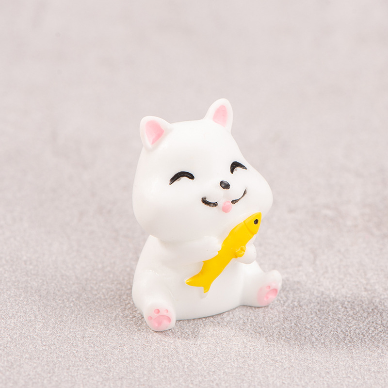 Kitten hugging dried fish