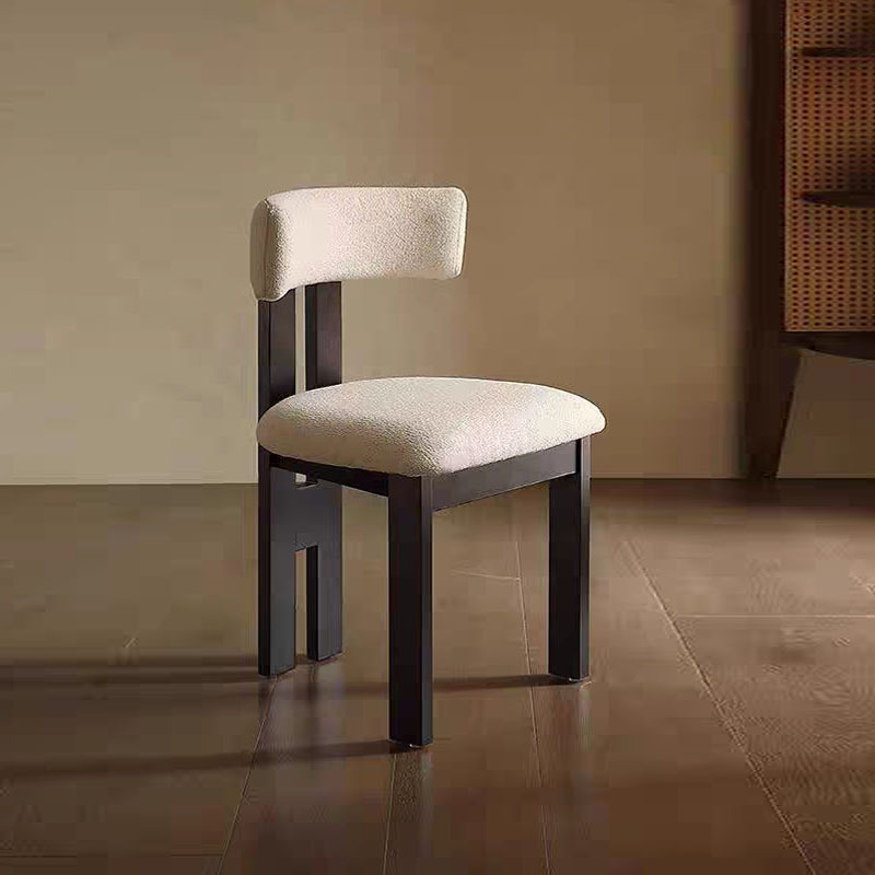 Fauteuil en laine d'agneau blanche, gris cendré avec motif en relief noir.