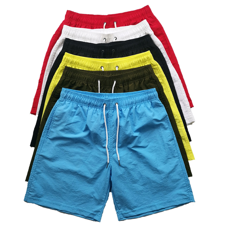 กางเกงว่ายน้ำขาสั้นผ้าไนลอนโพลีเอสเตอร์ Shorts100กางเกงว่ายน้ำสำหรับผู้ชายกางเกงขาสั้นตาข่ายชายหาดสำหรับผู้ชายมีโลโก้ตามสั่งสำหรับฤดูร้อน